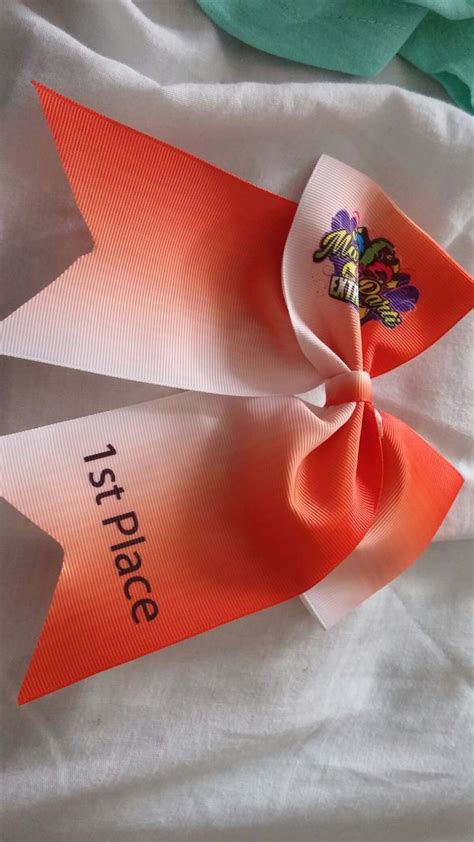 An Orange And White Bow With The Words Test Piece On It