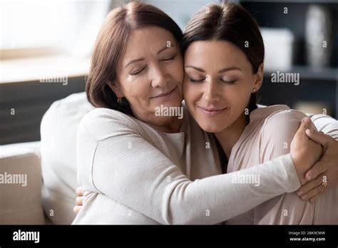 Mature Mother And Adult Daughter Hugging Enjoying Tender Moment Stock