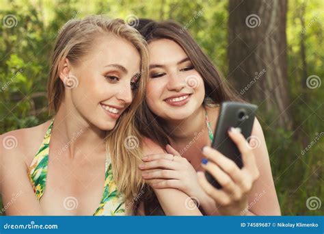 Two Happy Teenage Girls Taking Selfshot Or Selfy Picture Of Them Stock