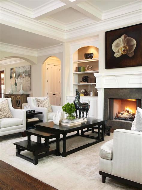 transitional living room features black stair step coffee table  elegant white