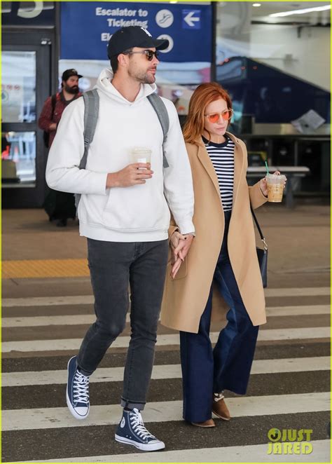 brittany snow and fiance tyler stanaland hold hands at lax
