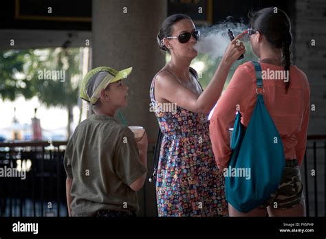 Passive Smoking Mother Smoking E Cigarette And Blowing Smoke Into