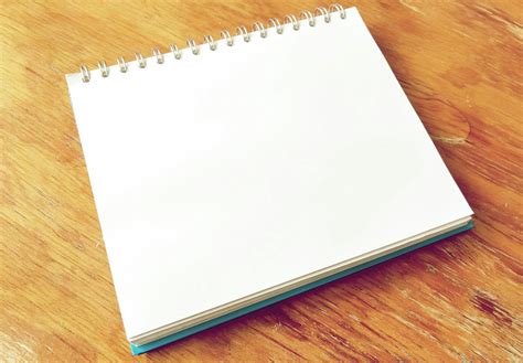 white notepad  brown surface  stock photo