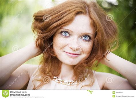 Portrait Of Redhead Girl With Blue Eyes On Nature Stock