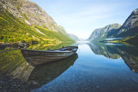 nature landscape fjord mountain boat reflection grass summer shrubs norway calm mist