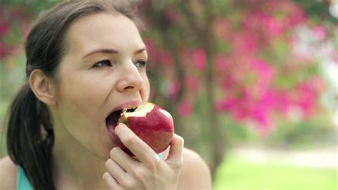 closeup of woman biting and eating apple stock footage