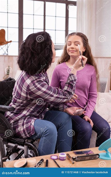 crippled woman helping girl  makeup stock photo image
