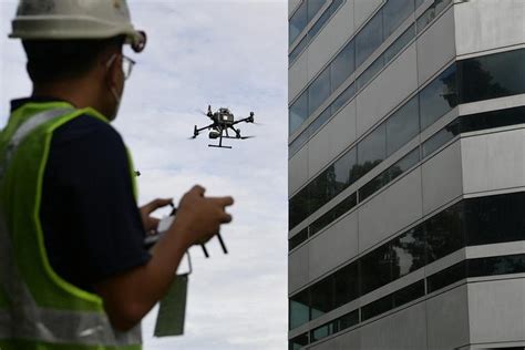 building owners urged   drones  facade inspections   bca guidelines rolled