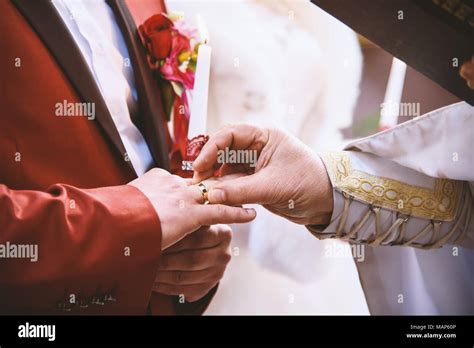 priest put wedding ring on grooms finger marriage vow christian