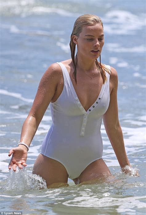 Margot Robbie Manages A Stylish Wipe Out Surfing In A White One Piece
