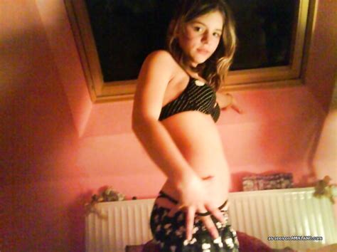 photo gallery of a blonde amateur kinky teen posing topless in the bedroom