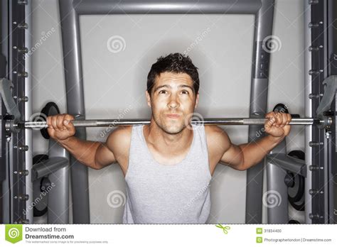 young man struggling  lift weights stock photo image