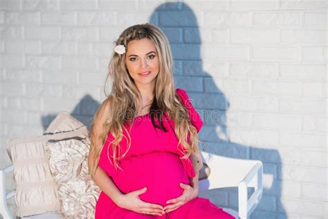 Portrait Of A Beautiful Pregnant Woman Bright Dress And Long Hair Stock