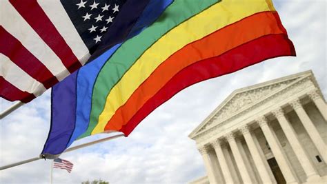an american flag and a rainbow flag fly in front of the supreme court