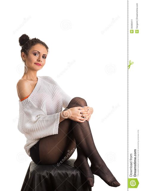 a girl sits hugging her knees stock image image of pullover lips