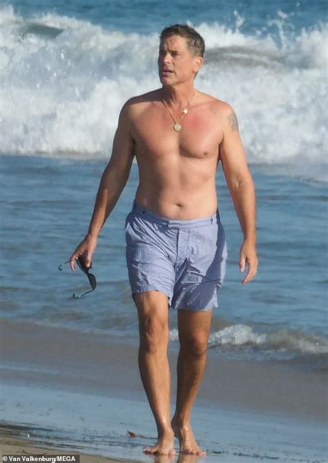 rob lowe 56 bares his muscles as he goes shirtless for a walk on the