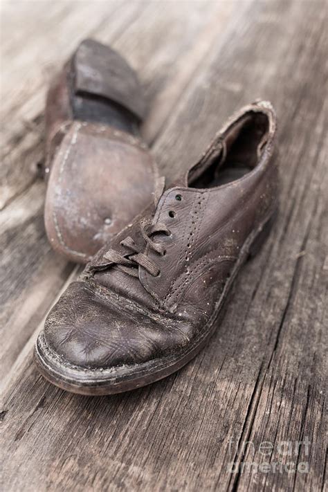 old leather shoes on wooden floor photograph by edward fielding