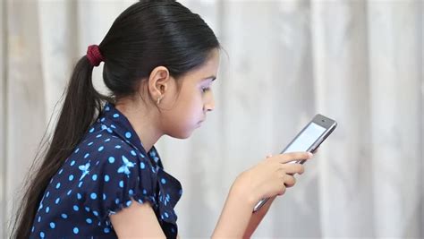 Indian Girl Playing Games On A Tab And Showing Thumbs Up