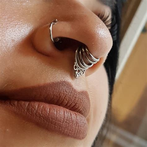 These Is A Septum Piercing That Has Been Stretched And Then Multiple