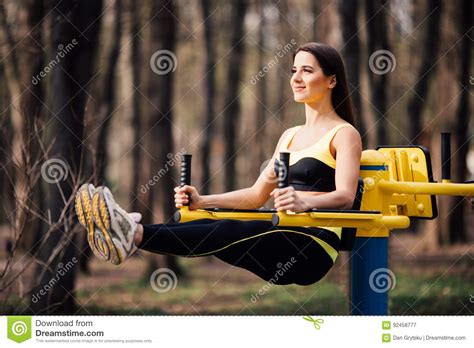 Woman Exercising With Exercise Equipment In The Public