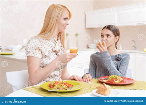 mother  daughter drink juice stock photo image  healthy home