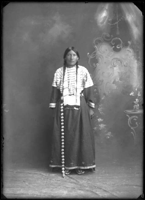 Native American Woman Standing In Full Dress Posing For