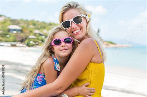 Outdoor Portrait Of Beautiful Blonde Mother And Her Cute Daughter