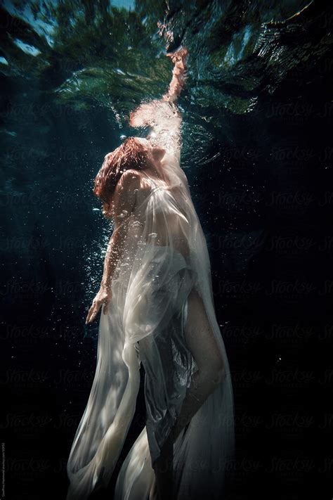 Woman Underwater Reaching To The Surface By Geoffrey Hammond