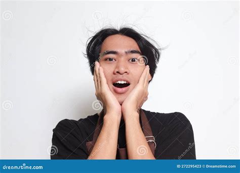 Close Up Portrait Of Shocked Asian Barista Man In Brown Apron Holding