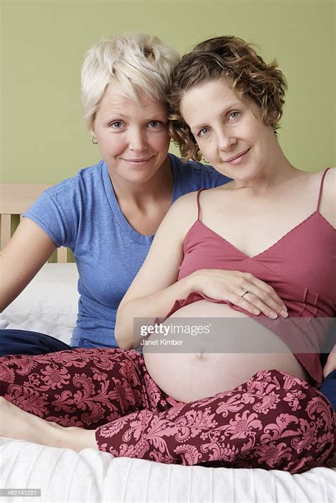 Caucasian Pregnant Lesbian Couple Relaxing On Bed Photo Getty Images