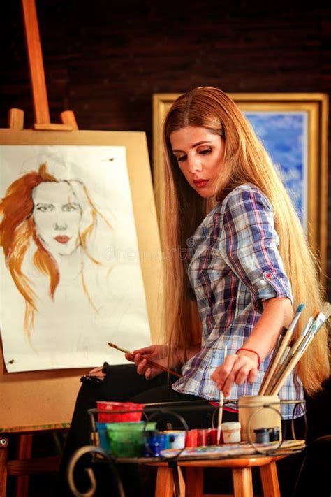 girl artist paints  painting brush  easel stock image image