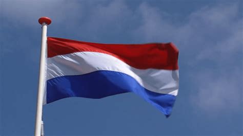 dutch flag in blue sky waving in wind the national flag of the kingdom