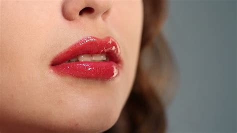 woman applying pink lip gloss close up stock footage