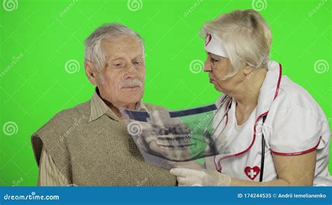 Mature Woman Nurse Doctor Examines Senior Patient Man With Problems