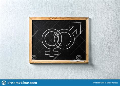 small blackboard with drawn gender symbols sex education