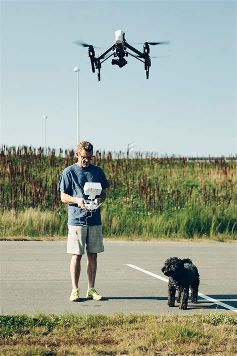 man dog drone  stocksy contributor photographer christian  stocksy