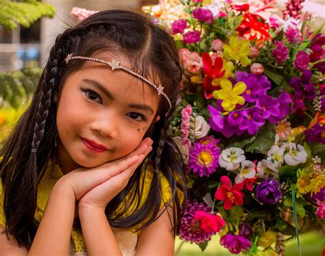 adorable little thai girl and flowers photograph by john greene
