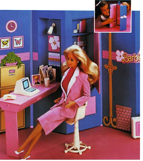 A Barbie Doll Sitting At A Pink Desk