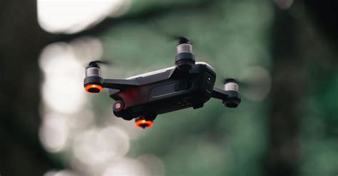 black quadcopter drone hovering mid air  stock photo