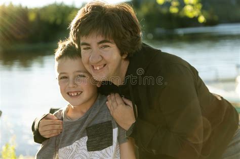 woman have fun his disabled sister close to a lake stock image image