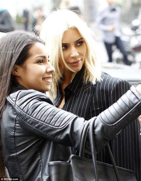 kim kardashian and kanye west get amorous on a parisian shopping trip