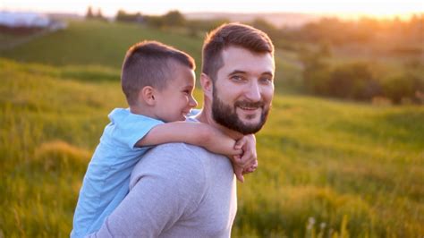 happy father and son enjoying sunset in field stock video footage 00 29