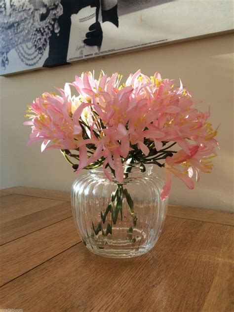 beautiful pink agapanthus artificial flower arrangement in glass vase