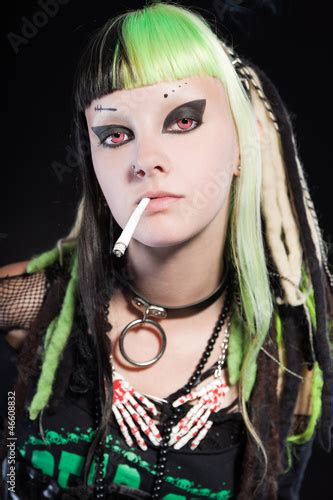 Cyber Punk Girl Red Eyes Smoking A Cigarette Against Black Wall