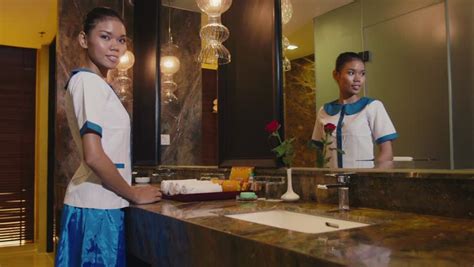 stock video of asian housekeeper cleaning hotel room