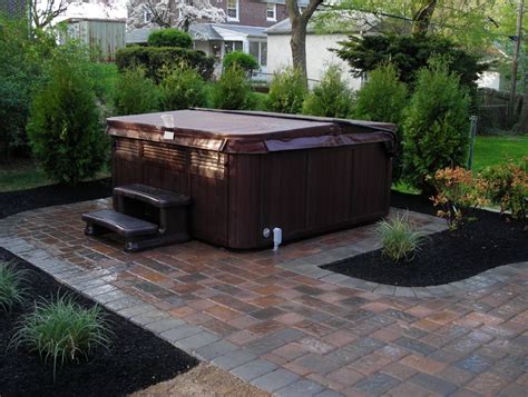 outdoor hot tub   middle   brick patio  trees  bushes