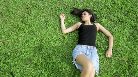 sexy erotic asian girl with mini skirt laying on grass stock footage video 2931967 shutterstock