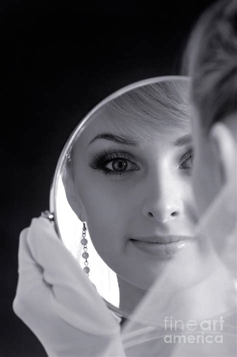 beautiful woman in bridal veil looking at a mirror by oleksiy maksymenko