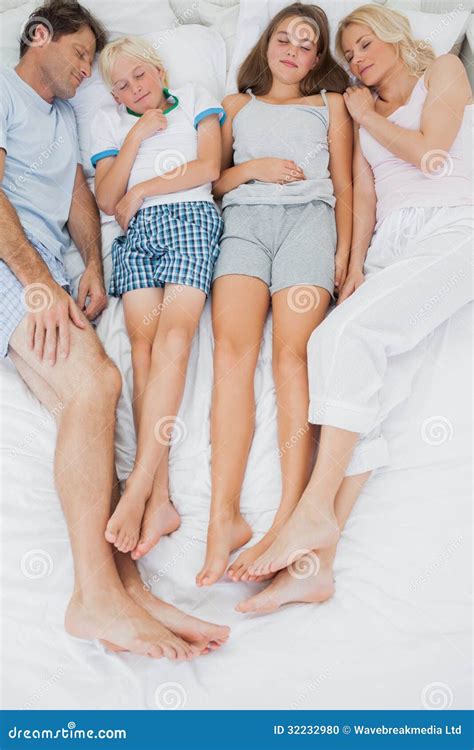 family sleeping  bed stock photo image
