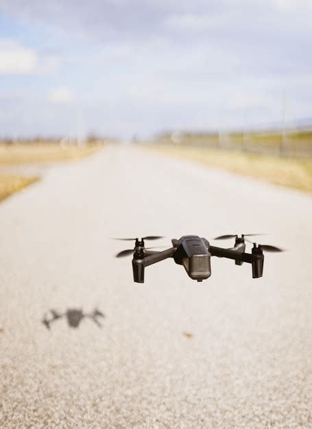 photo black quadcopter drone   cloudy sky